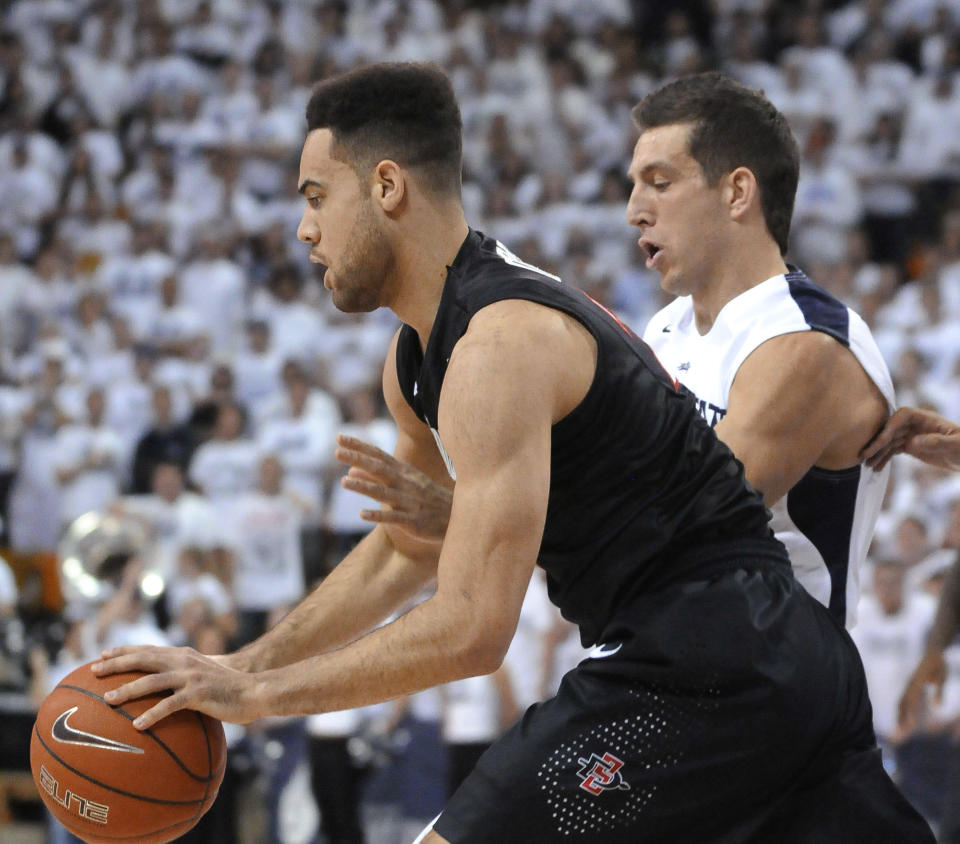 San Diego State forward JJ O'Brien grabs a rebound as Utah State guard/forward Spencer Butterfield defends during the first half of an NCAA college basketball game Saturday, Jan. 25, 2014, in Logan, Utah. (AP Photo/Eli Lucero)