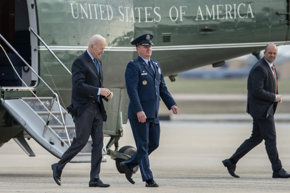 President Joe Biden escorted by Col. Matthew Jones, Commander of the 89th Airlift Wing, walks to board Air Force One at Andrews Air Force Base, Md., Wednesday, March 23, 2022. (AP Photo/Gemunu Amarasinghe)