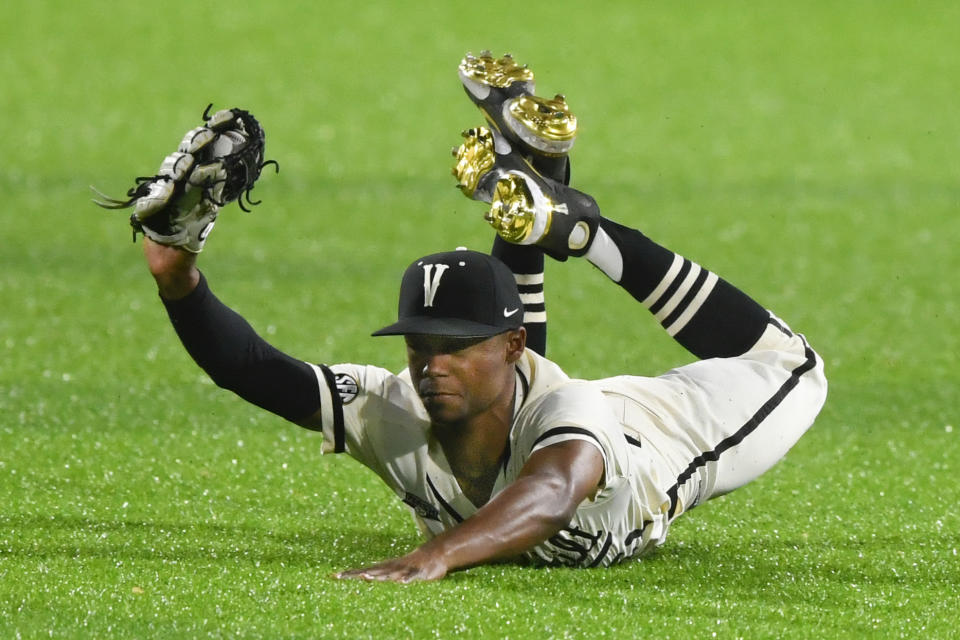 FILE -Vanderbilt's Enrique Bradfield Jr. makes a diving catch in the outfield to get out Eastern Kentucky's Brycen Collins during an NCAA college baseball game on Tuesday, April 13, 2021, in Nashville, Tenn. Bradfield went into Tuesday, May 24, 2022, 42 for 42 stealing bases this season and had swiped 47 in a row since he was caught trying to steal third against Arkansas last May 27. Bradfield's consecutive steals streak is the longest in at least a decade, according to NCAA records.(AP Photo/John Amis, File)