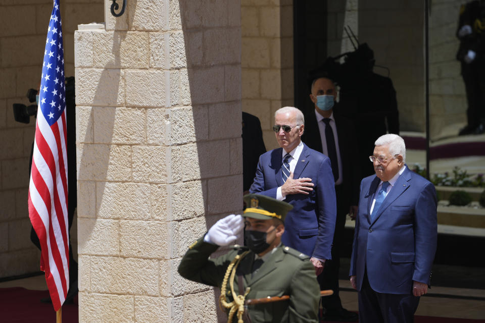 U.S. President Joe Biden and Palestinian President Mahmoud Abbas listen to the national anthem during a welcoming ceremony the West Bank town of Bethlehem, Friday, July 15, 2022. (AP Photo/Majdi Mohammed)