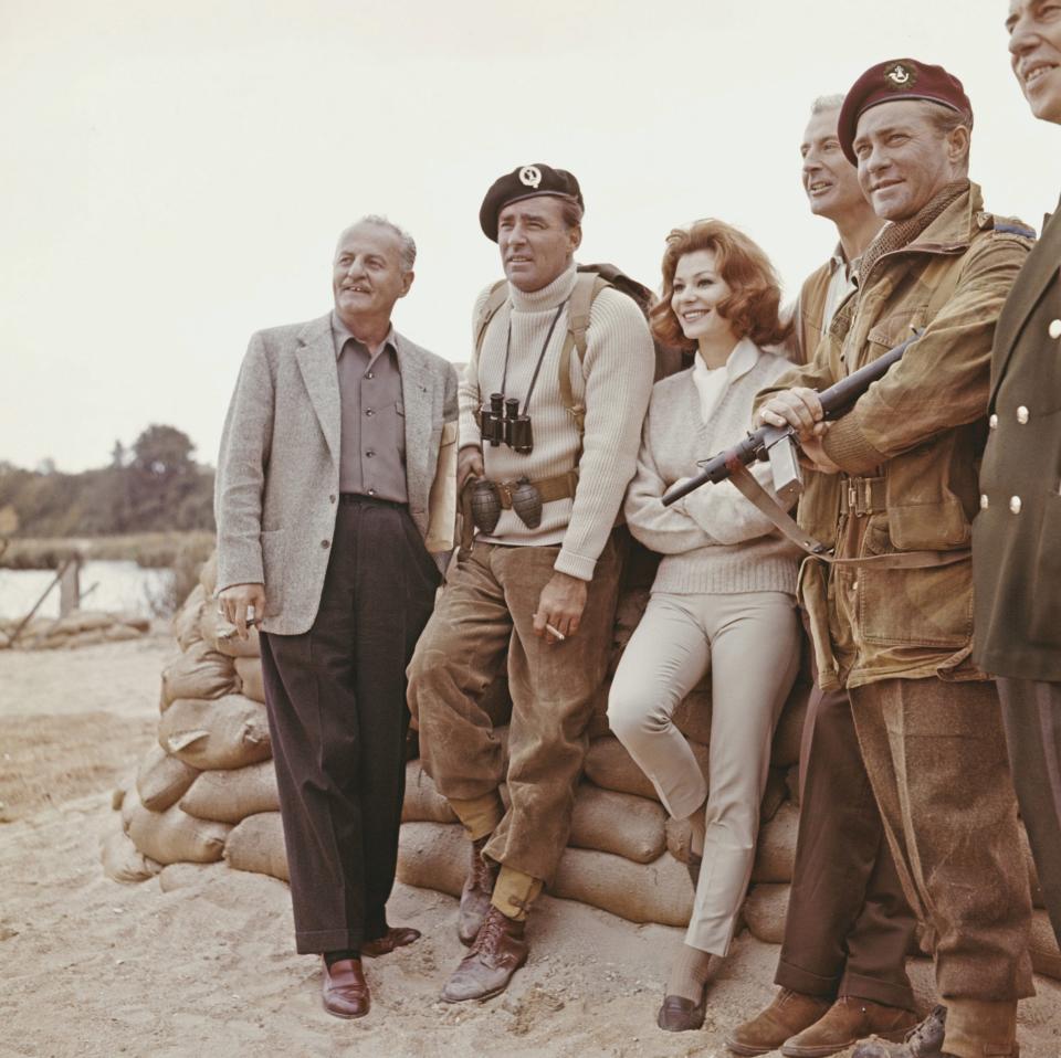 Darryl F Zanuck, left, left with Peter Lawford, Irina Demick and Richard Todd on location in France, 1961. Commando leader Simon Fraser, played by Peter Lawford, stands third from right - Getty