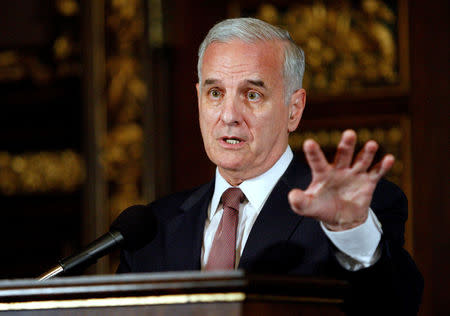 FILE PHOTO: Minnesota Gov. Mark Dayton speaks to media after signing bills to eliminate the state's $5 billion budget deficit and reopen state government and services that have been shut down for three weeks, in St. Paul, Minnesota, U.S. on July 20, 2011. REUTERS/Eric Miller/File Photo