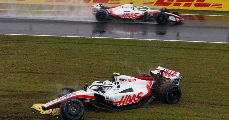Kevin Magnussen, Haas, drives past stricken team-mate Mick Schumacher. Japan, October 2022. Credit: Alamy