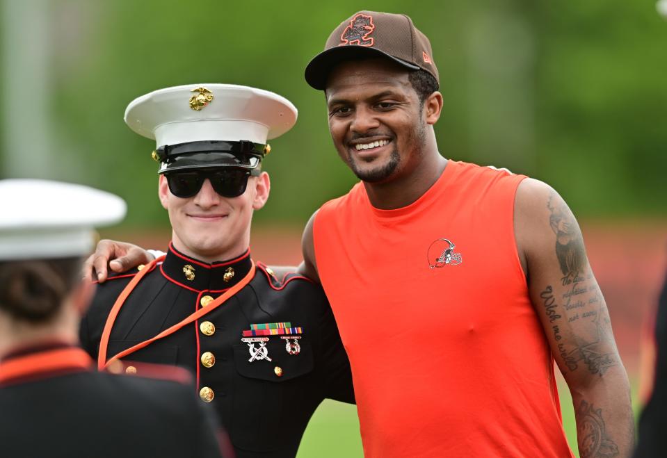 Browns quarterback Deshaun Watson poses for a photo with a member of the military during organized team activities in Berea, May 25, 2022.