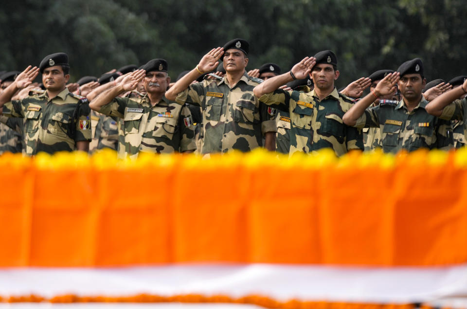 Indian Border Security Force (BSF) soldiers pay tribute to their colleague Lal Fam Kima during a wreath-laying ceremony at the BSF headquarters in Jammu, India, Thursday, Nov.9, 2023. The BSF soldier was killed as Indian and Pakistani soldiers exchanged gunfire and shelling along their highly militarized frontier in disputed Kashmir. (AP Photo/Channi Anand)