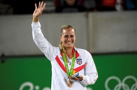2016 Rio Olympics - Tennis - Victory Ceremony - Women's Singles Victory Ceremony - Olympic Tennis Centre - Rio de Janeiro, Brazil - 13/08/2016. Gold medalist Monica Puig (PUR) of Puerto Rico reacts after receiving her medal. REUTERS/Toby Melville