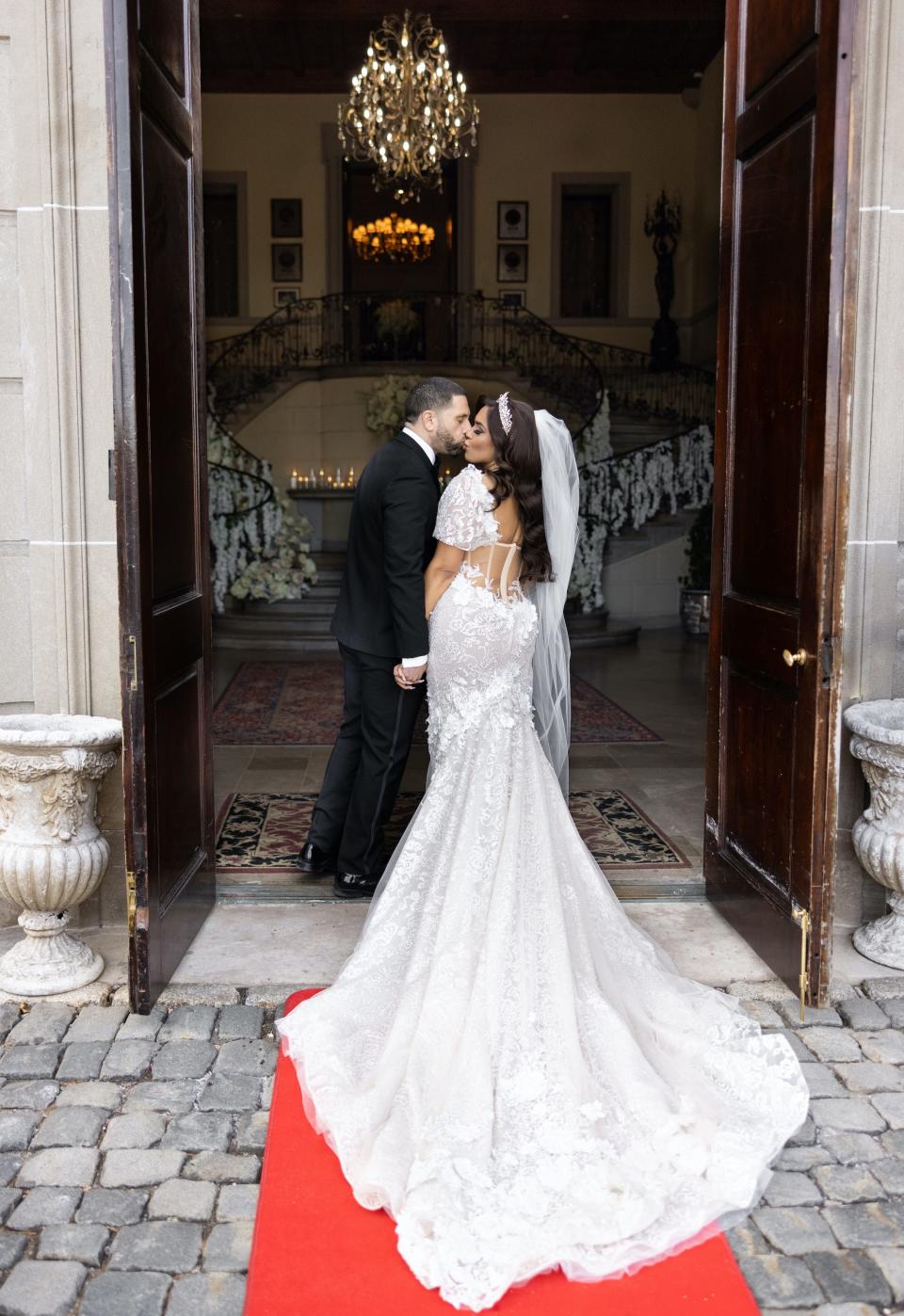 Vishnell and her husband kiss under a doorway