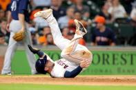Jun 6, 2018; Houston, TX, USA; Houston Astros third baseman Alex Bregman (2) falls over after being tagged out at home by Seattle Mariners catcher Mike Zunino (3, not shown) during the third inning at Minute Maid Park. Mandatory Credit: Erik Williams-USA TODAY Sports