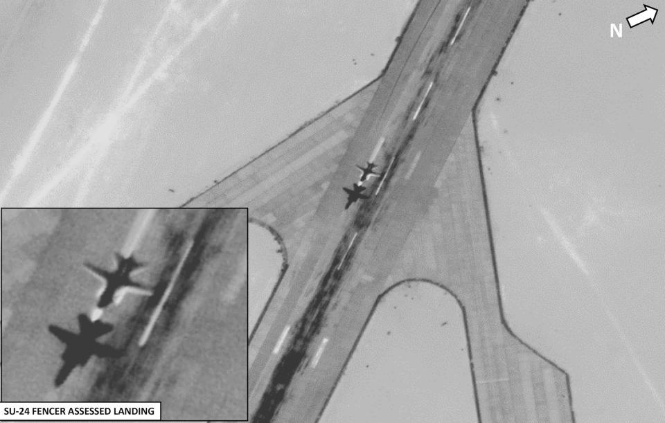 A black and white surveillance image of Russian jets taking off from a runway in Libya.