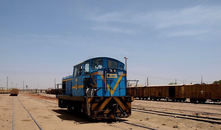 An engine moves along Sudan's narrow-guage track in the sidings of Khartoum's station in March 2011. The freight train rumbles over the Blue Nile bridge and snakes through the capital. It could take weeks to reach its destination, in Darfur, for despite the potential to link up a divided nation, Sudan's railways are derelict, after years of sanctions and neglect