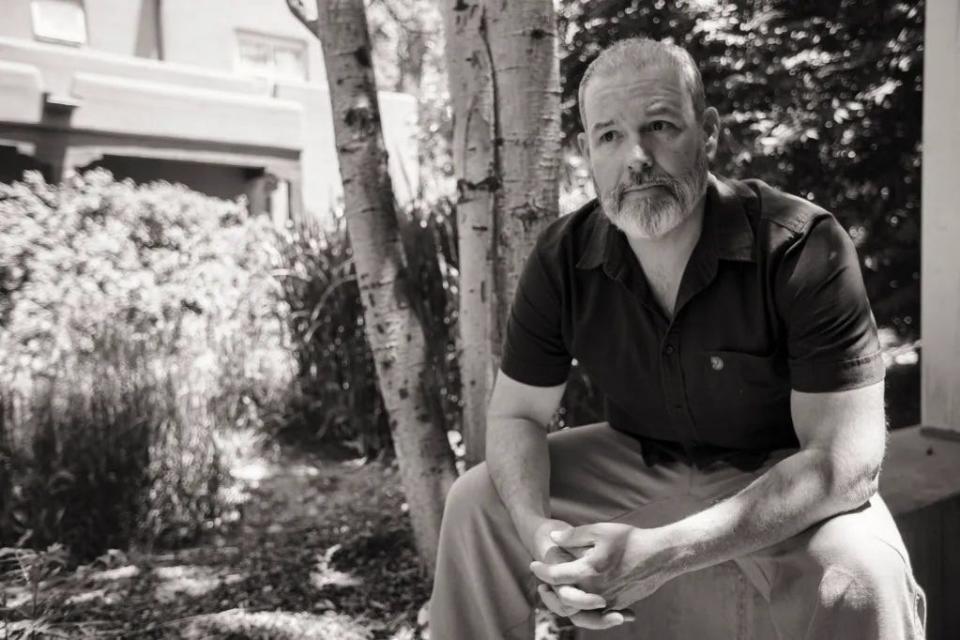 Erik Schlenker-Goodrich sits outside the Taos office of the Western Environmental Law Center.