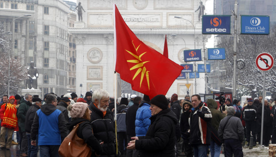 People attend a protest against the change of the country's name outside the parliament building during a session of the Macedonian Parliament in the capital Skopje, Friday, Jan. 11, 2019. Macedonia has fulfilled its part of a deal that will pave its way to NATO membership and normalize relations with neighboring Greece, after lawmakers approved constitutional changes that will rename the country North Macedonia. (AP Photo/Boris Grdanoski)