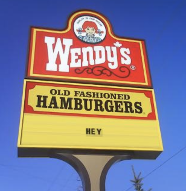 sign reading hey below a Wendy's logo