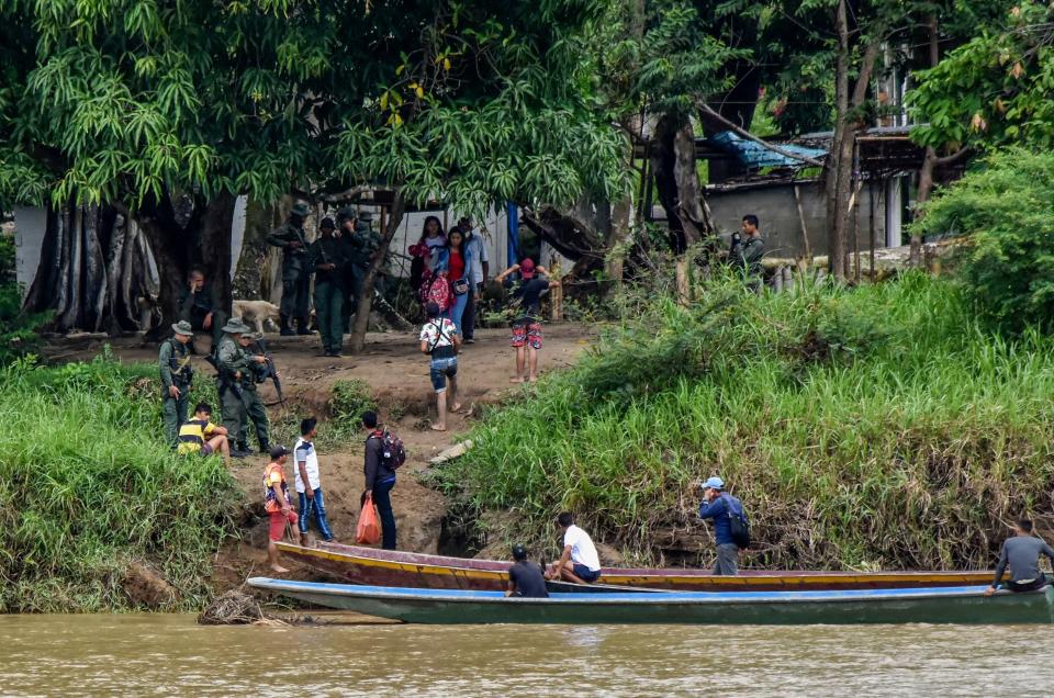 Venezuelans cross the Arauca river from La Victoria, Apure state, Venezuela to Arauquita municipality, Arauca department, Colombia, on March 26, 2021. 