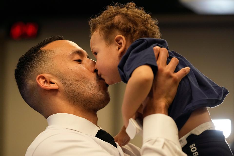 Carlos Correa kisses his son Kylo at his Twins press conference.