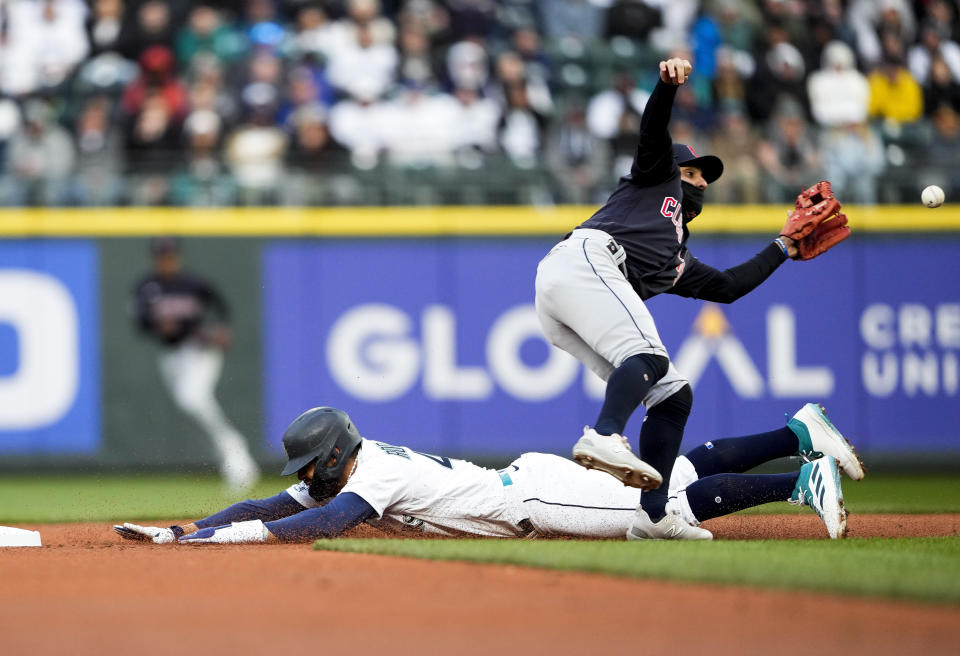 Seattle Mariners' Julio Rodriguez steals second as Cleveland Guardians second baseman Andres Gimenez waits for the throw during the first inning of a baseball game Saturday, April 1, 2023, in Seattle. (AP Photo/Lindsey Wasson)