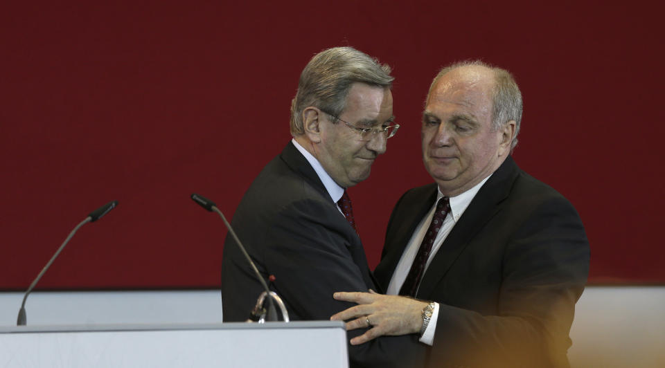 Former FC Bayern Munich president Uli Hoeness, right, hugs CFO and candidate Karl Hopfner as he arrives for an extraordinary members meeting, in Munich, southern Germany, Friday, May 2, 2014. The club is voting for a new president. (AP Photo/Matthias Schrader)