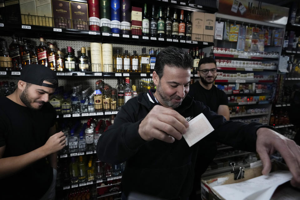 Store co-owner Nidal Khalil, center, goes over the previous day's lottery ticket sales with nephew Chris Khalil, left, and son Jonathan Khalil, right, at the Midway Market & Liquor store, Thursday, Oct. 12, 2023, in Frazier Park, Calif., where a winning Powerball lottery ticket was sold. A player in California won a $1.765 billion Powerball jackpot Wednesday night, ending a long stretch without a winner of the top prize. (AP Photo/Marcio Jose Sanchez)