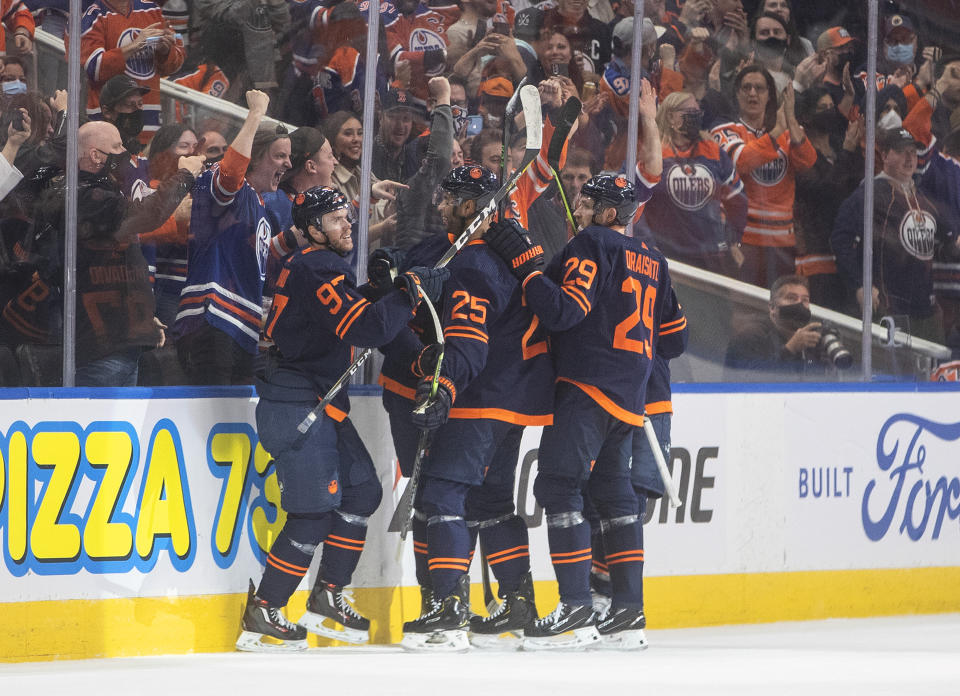 Edmonton Oilers' Connor McDavid (97), Darnell Nurse (25) and Leon Draisaitl (29) celebrate a goal against the Calgary Flames during the first period of an NHL hockey game Saturday, Oct. 16, 2021, in Edmonton, Alberta. (Jason Franson/The Canadian Press via AP)