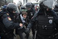 FILE - In this Jan. 23, 2021, file photo, police officers detain a man during a protest against the jailing of opposition leader Alexei Navalny in Moscow, Russia. Allies of Navalny are calling for new protests next weekend to demand his release, following a wave of demonstrations across the country that brought out tens of thousands in a defiant challenge to President Vladimir Putin. (AP Photo/Pavel Golovkin, File)