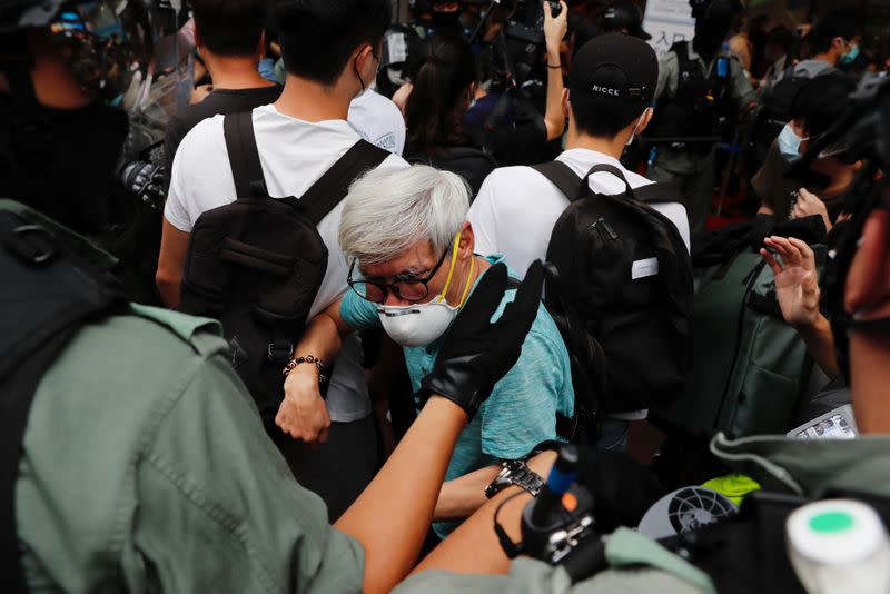 Riot police disperse anti-national security law protesters during a march at the anniversary of Hong Kong's handover to China from Britain in Hong Kong