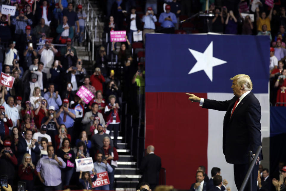 President Donald Trump points into the crowd during a campaign rally for Sen. Ted Cruz, R-Texas, at Houston Toyota Center, Monday, Oct. 22, 2018, in Houston. (AP Photo/Evan Vucci)