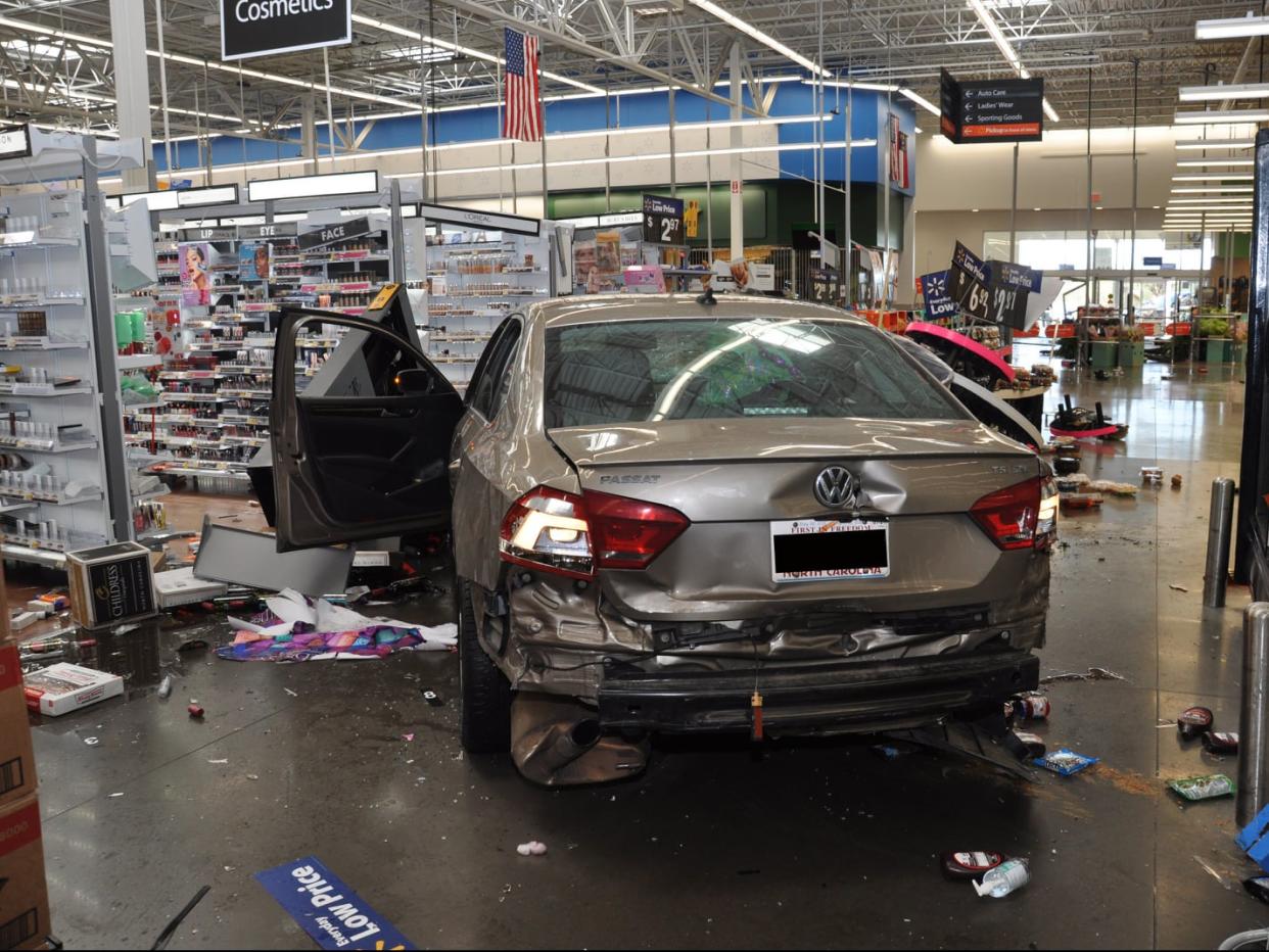 <p>Pictures released by Concord police show damage caused to a Walmart store on 2 April</p> (Concord Police Department)