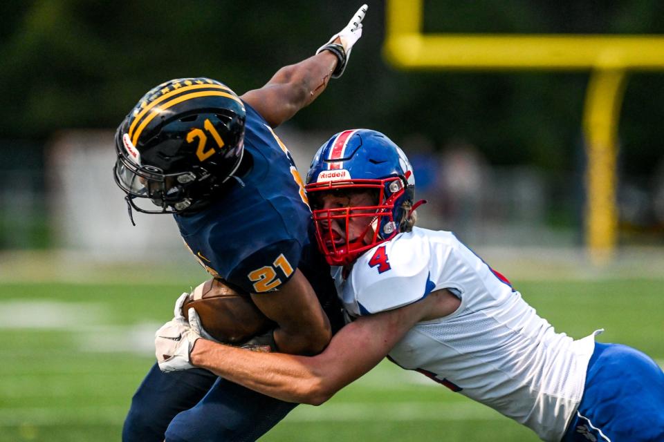 Mason's Kaleb Parrish, right, tackles Haslett's Nakai Amachree during the first quarter on Friday, Sept. 23, 2022, at Haslett High School.
