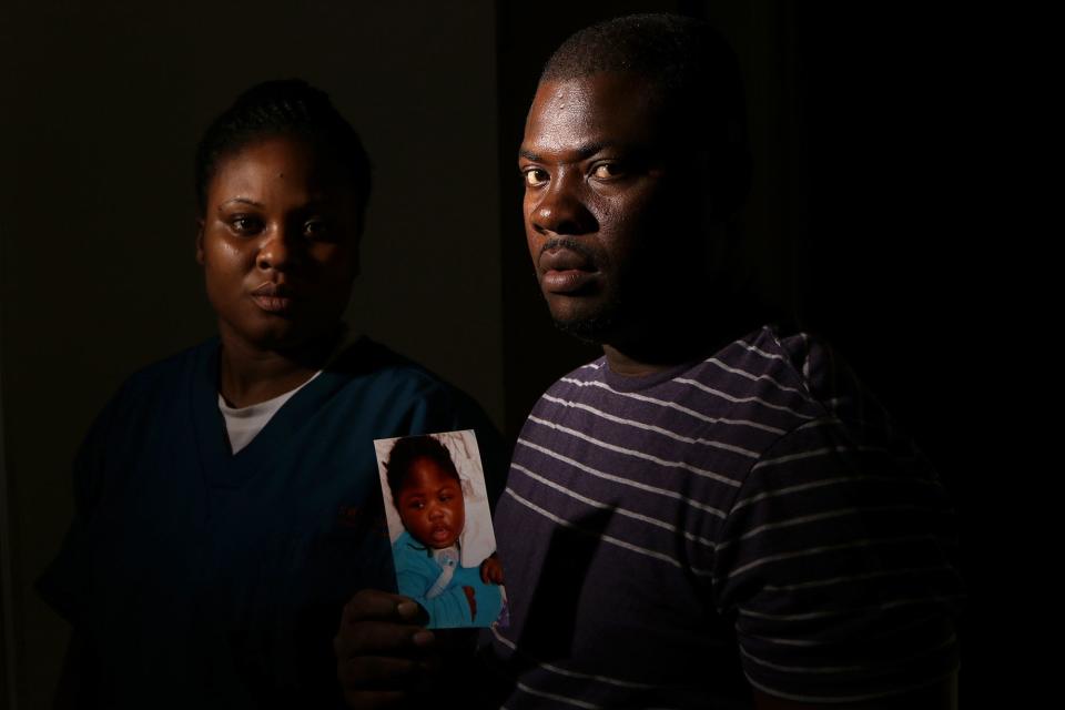 Ocroimy Dolcin and his wife, Modeline Auguste, pose with a photo of their daughter, Dorcase Dolcin, who was one of at least ten people who died, at the Wanaque Center for Nursing and Rehabilitation last month of an adenovirus outbreak. Thursday, November 1, 2018