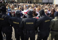 Women react, standing in front of police line during an opposition rally to protest the official presidential election results in Minsk, Belarus, Saturday, Sept. 12, 2020. Daily protests calling for the authoritarian president's resignation are now in their second month and opposition determination appears strong despite the detention of protest leaders. (Tut.by via AP)