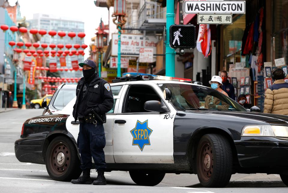 A San Francisco police officer stands guard on Grant Avenue in Chinatown on March 17, 2021 in San Francisco, California. The San Francisco police have stepped up patrols in Asian neighborhoods in the wake of a series of shootings at spas in the Atlanta area that left eight people dead, including six Asian women. The main suspect, Robert Aaron Long, 21, has been taken into custody. The San Francisco Bay Area is also seeing an increase in violence against the Asian community.