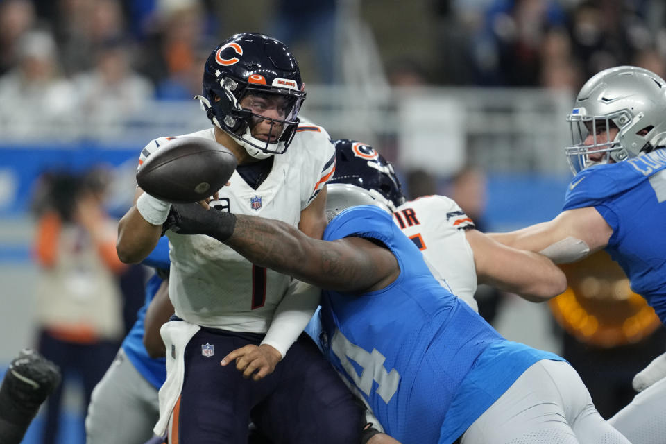 Chicago Bears quarterback Justin Fields (1) is sacked during the second half of an NFL football game against the Detroit Lions, Sunday, Jan. 1, 2023, in Detroit. (AP Photo/Paul Sancya)