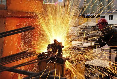 A worker welds at a construction site in Yiliang, Yunnan province, February 28, 2015. REUTERS/Stringer