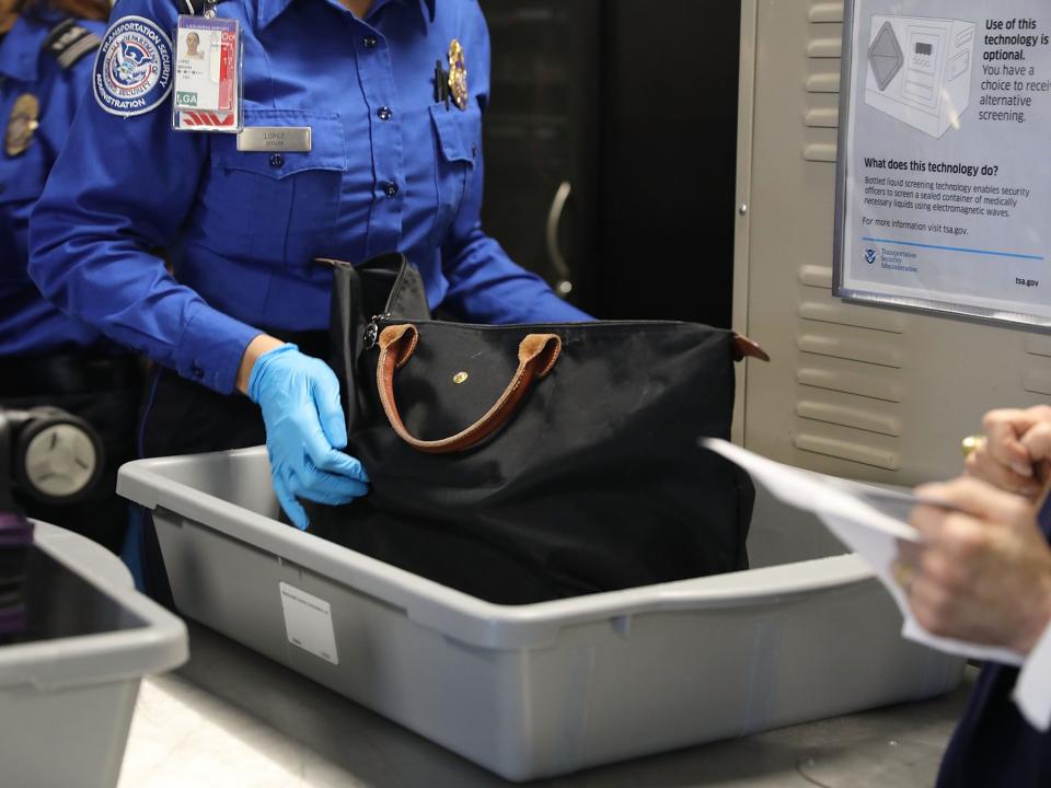 <p>A Transportation Security Administration (TSA) worker screens luggage at LaGuardia Airport (LGA) on 26 September 2017 in New York City</p> ((Getty Images))