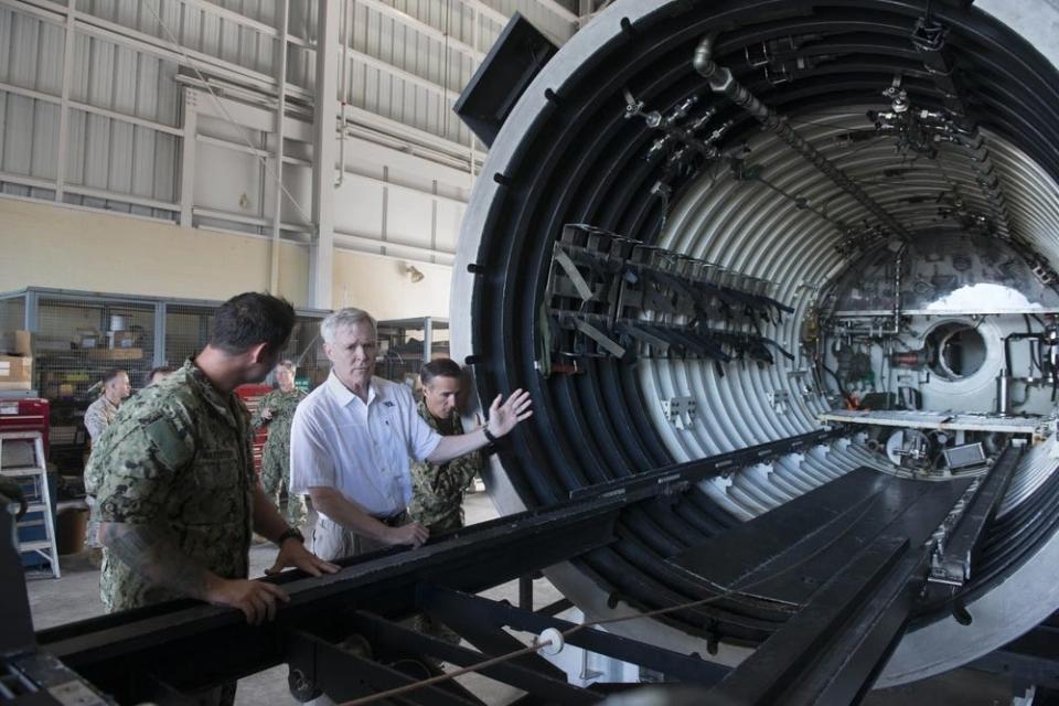 Former Secretary of the Navy Ray Mabus is briefed on equipment, capabilities, and ongoing missions by SEAL Delivery Vehicle Team One