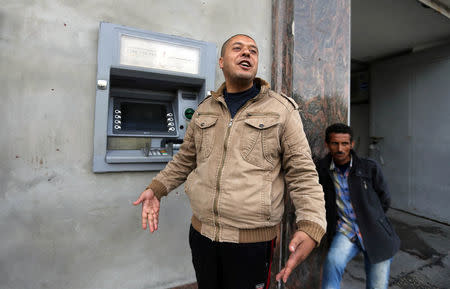A Palestinian Authority public servant gestures outside a bank in Gaza City April 12, 2018. REUTERS/Ibraheem Abu Mustafa