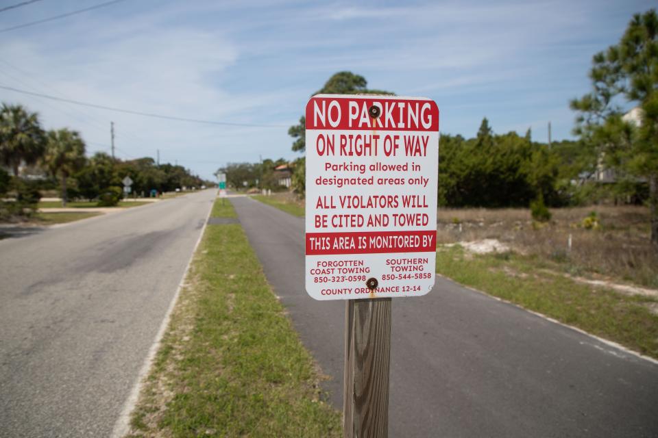 Signs that read “no parking” are posted along the side of the road in Alligator Point to deter tourists from parking in the roadway Thursday, March 14, 2024.