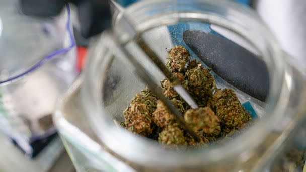 PHOTO: An employee at the Good Leaf Dispensary measures out marijuana for a customer on the reservation Mohawks call Akwesasne, Monday, March 14, 2022, in St. Regis, N.Y.  (Seth Wenig/AP, FILE)