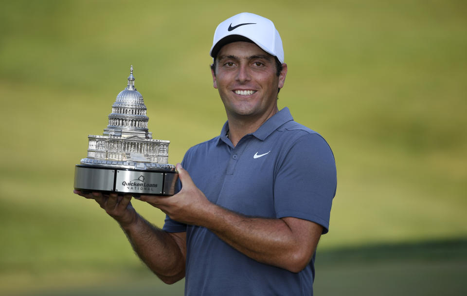 Francesco Molinari, of Italy, poses with the trophy after he won the Quicken Loans National golf tournament, Sunday, July 1, 2018, in Potomac, Md. (AP Photo/Nick Wass)