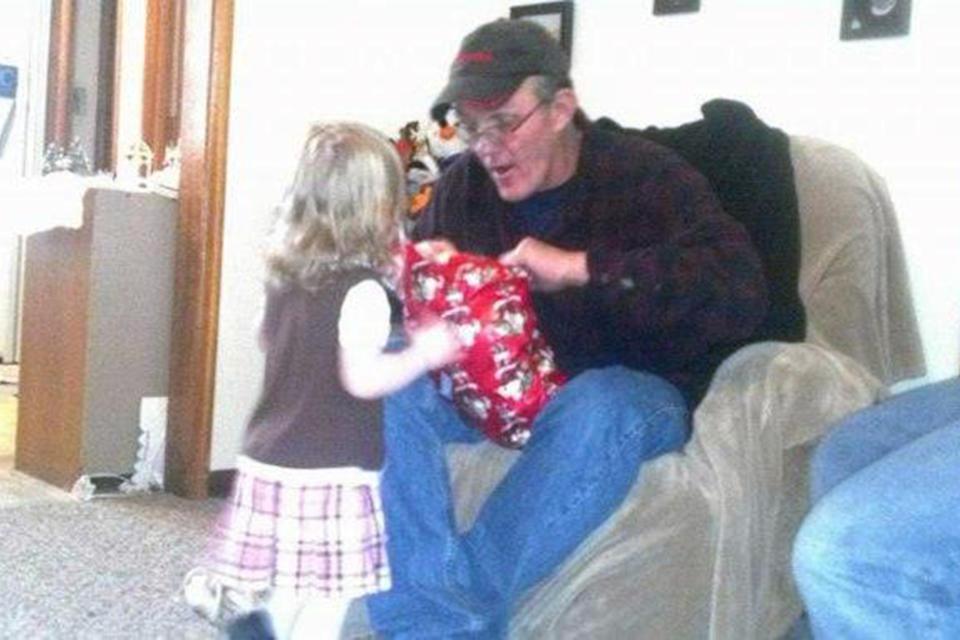 This photo provided by the family shows Brian Hays, of Muscatine, Iowa, with his granddaughter. When his wife, Sandra Jones, set out to unravel the circumstances of his death after his 2015 encounter with police, she said police wouldn’t hand over their reports. A detective later told her officers had shocked Hays and tied his feet before he went into cardiac arrest. She couldn’t glean why that much force was necessary. (Courtesy Sandra Jones via AP)