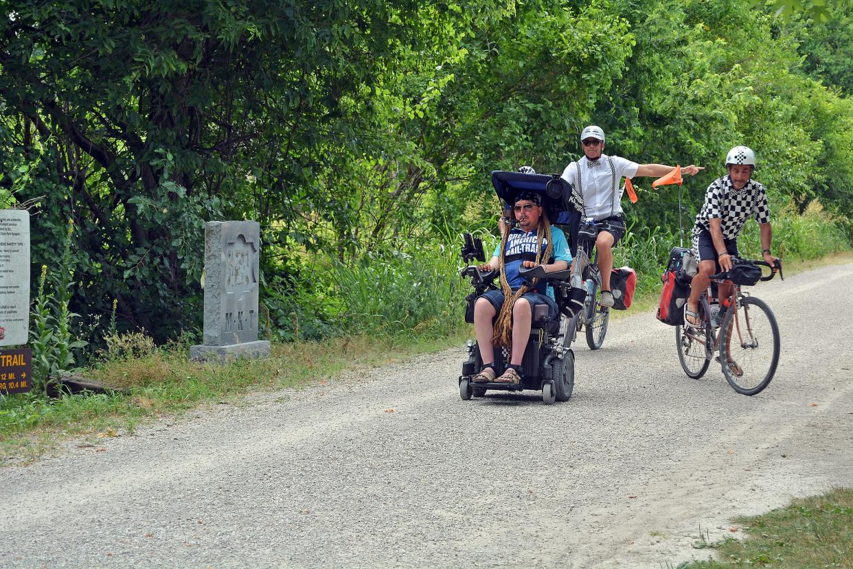 Accessibility advocate Ian Mackay, left, starts his trek Monday from the Katy Trail North Jefferson Trailhead headed toward Rocheport, supported by Jimmy Quenelle and Josh Blaustein.