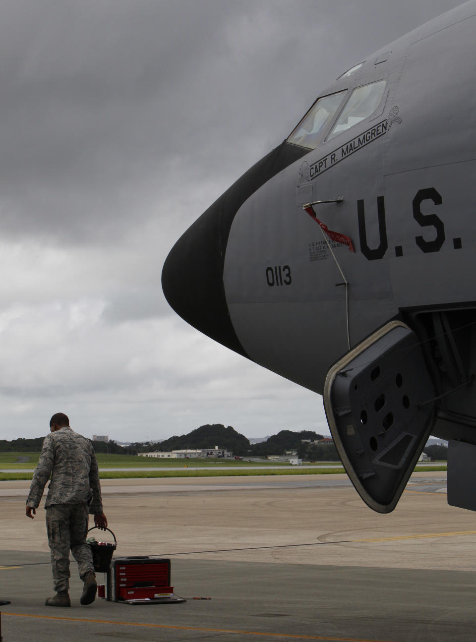 In this Aug. 14, 2012 photo, a ground crew member stands in front of a U.S. Air Force KC-135 Stratotanker, which was built in 1958, at Kadena Air Base on Japan's southwestern island of Okinawa. For decades, the U.S. Air Force has grown accustomed to such superlatives as unrivaled and unbeatable. Now some of its key aircraft are being described with terms like decrepit. (AP Photo/Greg Baker)