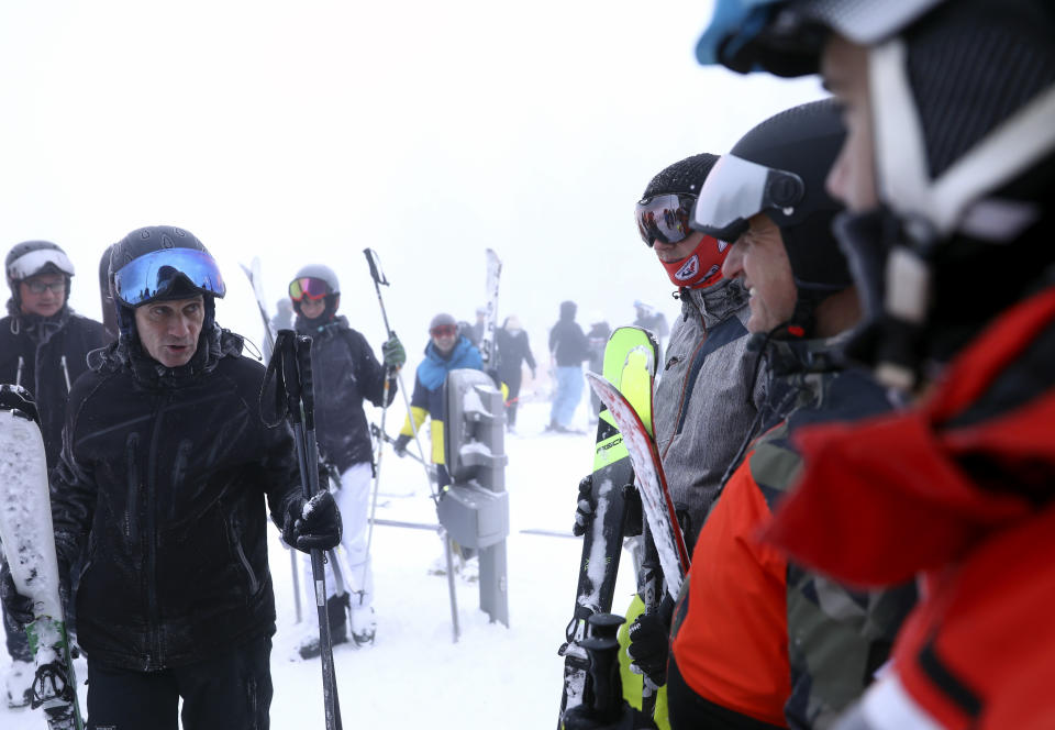 Skiers wait in a lift line on Mount Jahorina, 30 kilometers south of the Bosnian capital of Sarajevo, Saturday, Dec. 11, 2021. As most of Europe reintroduces measures to help curb the spread of the omicron variant, Bosnia, to the delight of its winter tourism industry, still maintains a relatively laissez-fair approach to the soaring COVID-19 infection numbers across the continent. (AP Photo/Marjan Vucetic)