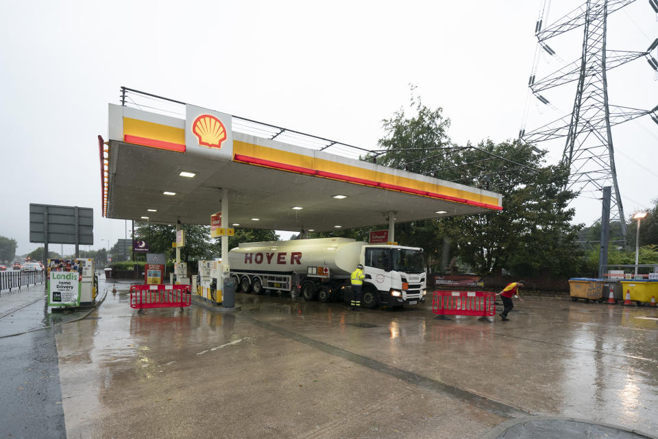 A fuel delivery is made to a petrol station in Manchester which had run out of fuel after an outbreak of panic buying in the UK, Monday, Sept. 27, 2021. British Prime Minister Boris Johnson is said to be considering whether to call in the army to deliver fuel to petrol stations as pumps ran dry after days of panic buying. ( AP Photo/Jon Super)