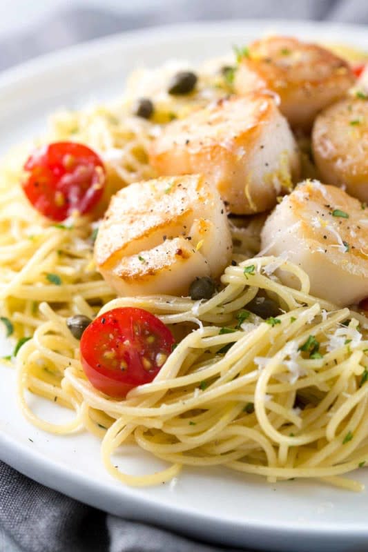 <p>Jessica Gavin</p><p>Pan-seared scallops with lemon caper pasta is a gourmet recipe for any occasion! Light angel hair pasta is tossed with a citrus white wine sauce and tomatoes.</p><p><strong>Get the recipe: <a href="https://www.jessicagavin.com/pan-seared-scallops-lemon-caper-pasta/" rel="nofollow noopener" target="_blank" data-ylk="slk:Pan-Seared Scallops with Lemon Caper Pasta;elm:context_link;itc:0;sec:content-canvas" class="link ">Pan-Seared Scallops with Lemon Caper Pasta</a></strong></p><p><strong>Related: <a href="https://parade.com/1351365/felicialim/canned-salmon-recipes/" rel="nofollow noopener" target="_blank" data-ylk="slk:Easy Recipes with Canned Salmon;elm:context_link;itc:0;sec:content-canvas" class="link ">Easy Recipes with Canned Salmon</a></strong></p>