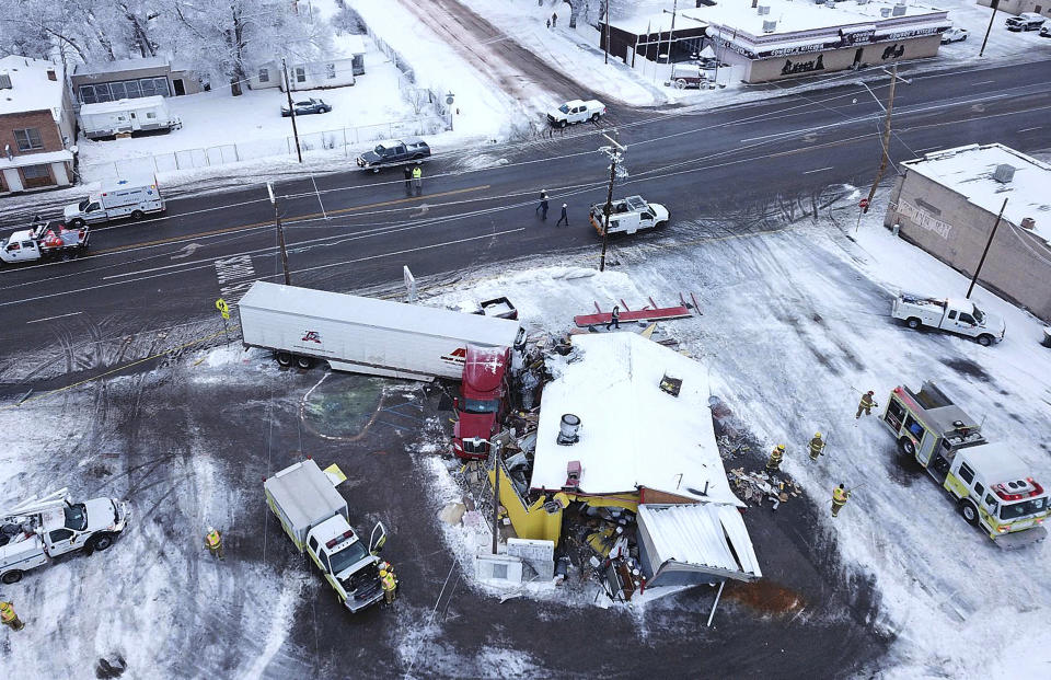 FILE - This Jan. 16, 2019 photo taken by a Utah Highway Patrol drone shows a big rig that has crashed into a resaturant in Wellington, Utah. In Utah, drones are hovering near avalanches to measure roaring snow. In North Carolina, they're combing the skies for the nests of endangered birds. In Kansas, meanwhile, they could soon be identifying sick cows through heat signatures. A survey released Monday, May 20, 2019 shows transportation agencies are using drones in nearly every U.S. state. (Utah Highway Patrol via AP, File)