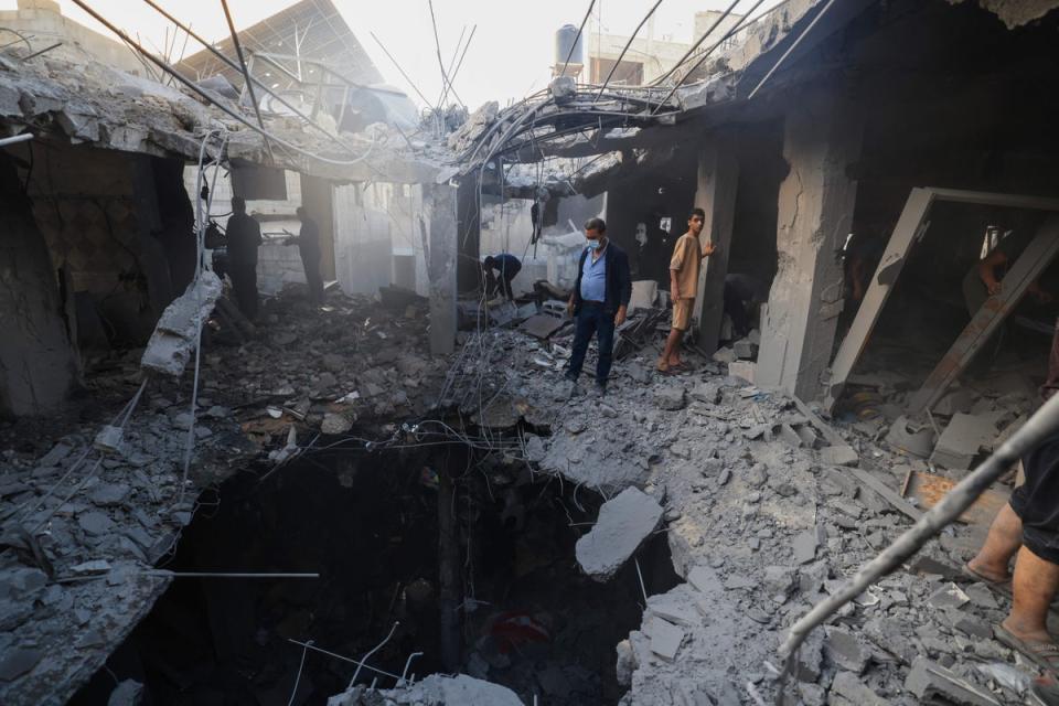 Palestinians search the rubble of a building for survivors follwoing Israeli bombardment in Khan Yunis in the southern Gaza Strip on 18 November 2023 amid ongoing battles between Israel and the Palestinian militant group Hamas. (AFP via Getty Images)