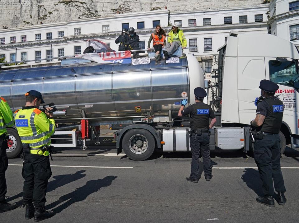 Police officers remove two Insulate Britain protesters from the top of a tanker at the Port of Dover after the glue themselves to vehicle (Gareth Fuller/PA)