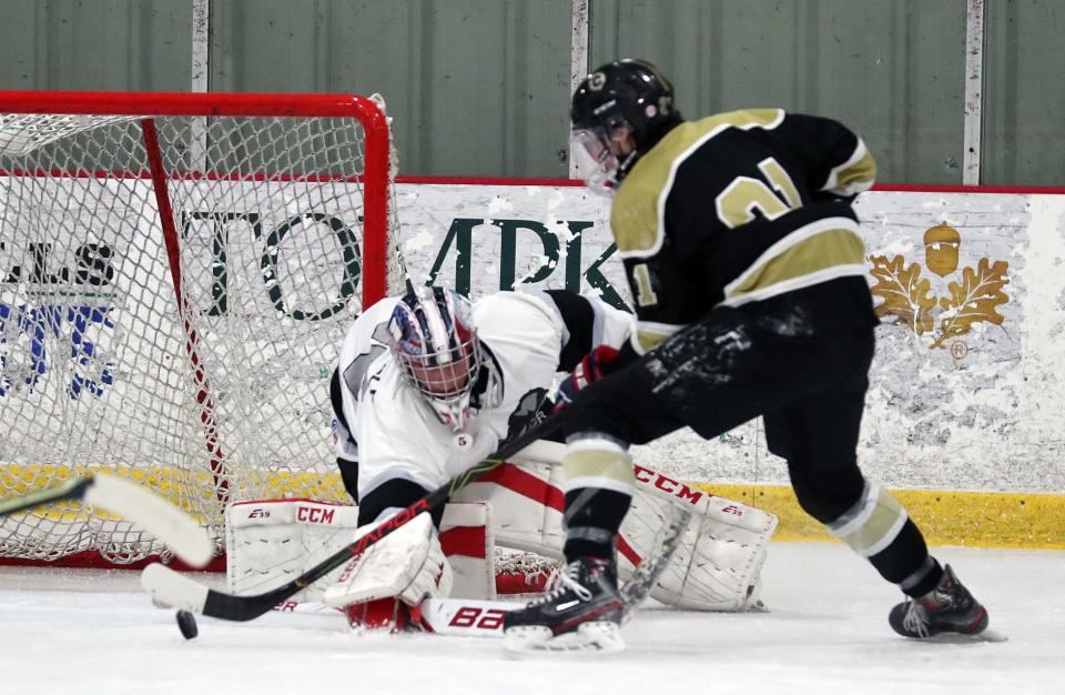 From right, Clarkstown's Nick Romeo (21) scores a first period goal on BYSNS's goalie Ty Wingfield during hockey action at the Brewster Ice Arena Jan. 15, 2022. 