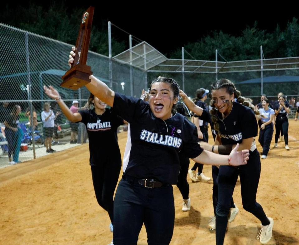 Somerset Academy Silver Palms Arlene Sordo (5) carries the regional softball championship after defeating the Coral Springs Charter softball team at Betti Stradling Park in Coral Springs, Florida on Friday, May 19, 2023. Coral Springs Charter varsity softball team lost their home playoff game against Somerset Academy Silver Palms of Miami by a score of 1-0.